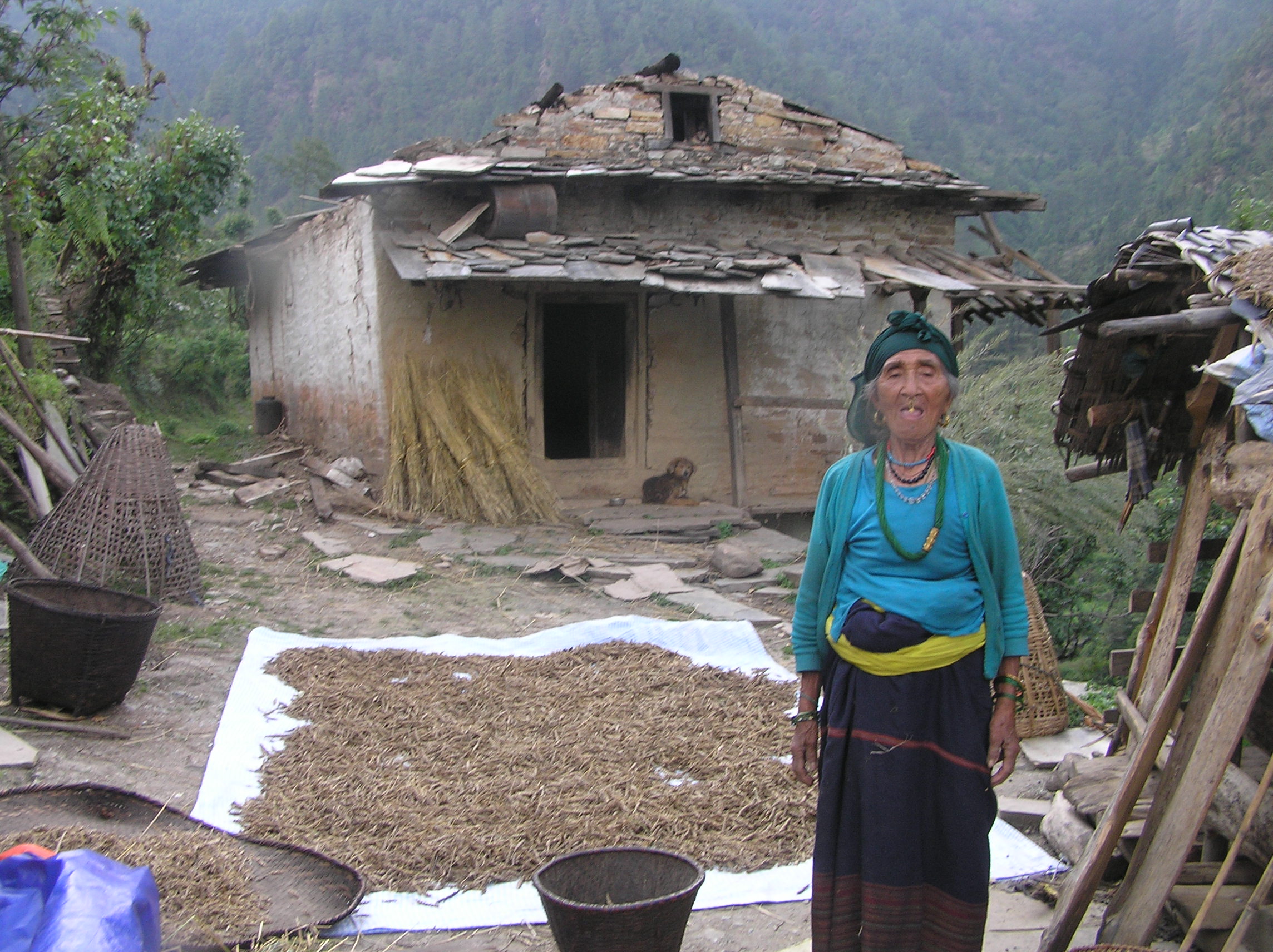 Bhim-Bahadur-Tamangs-mother-infront-of-her-damaged-house.
